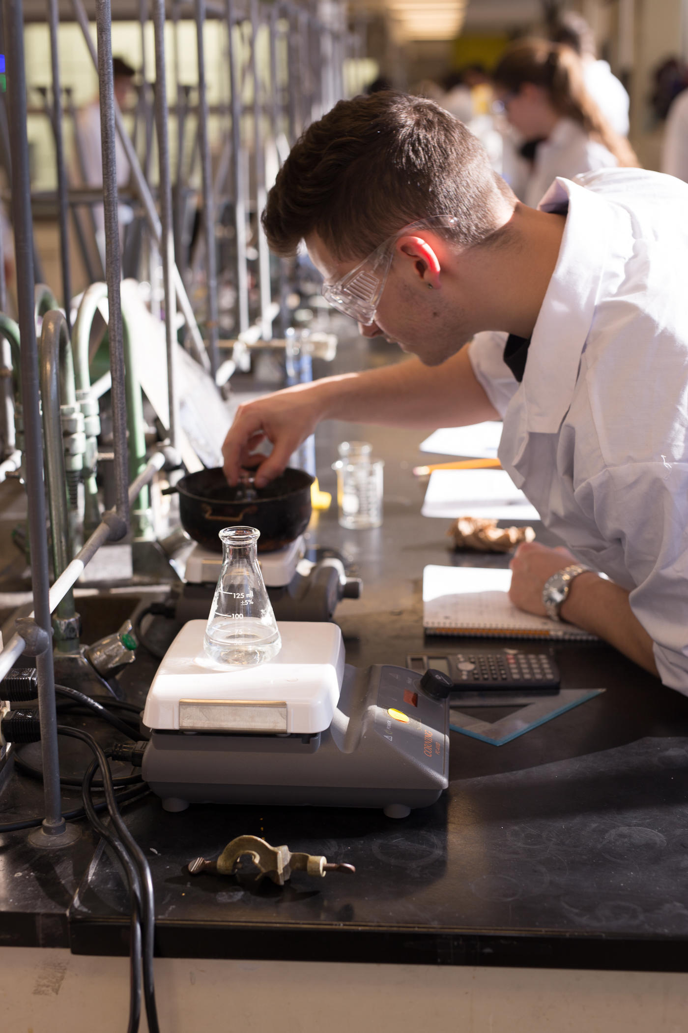 Students measuring liquid sample in a lab