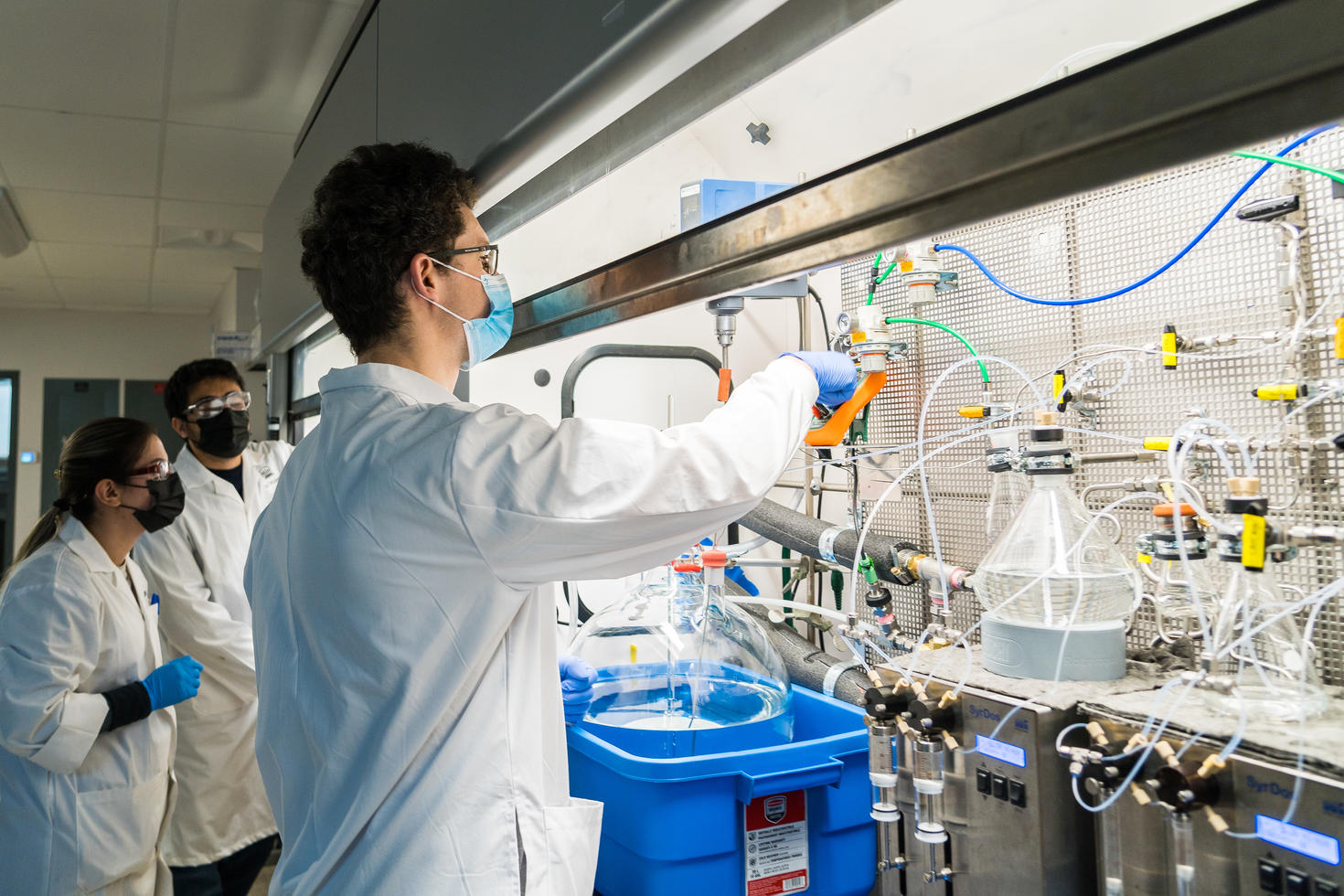 Student working in the lab under a fumehood