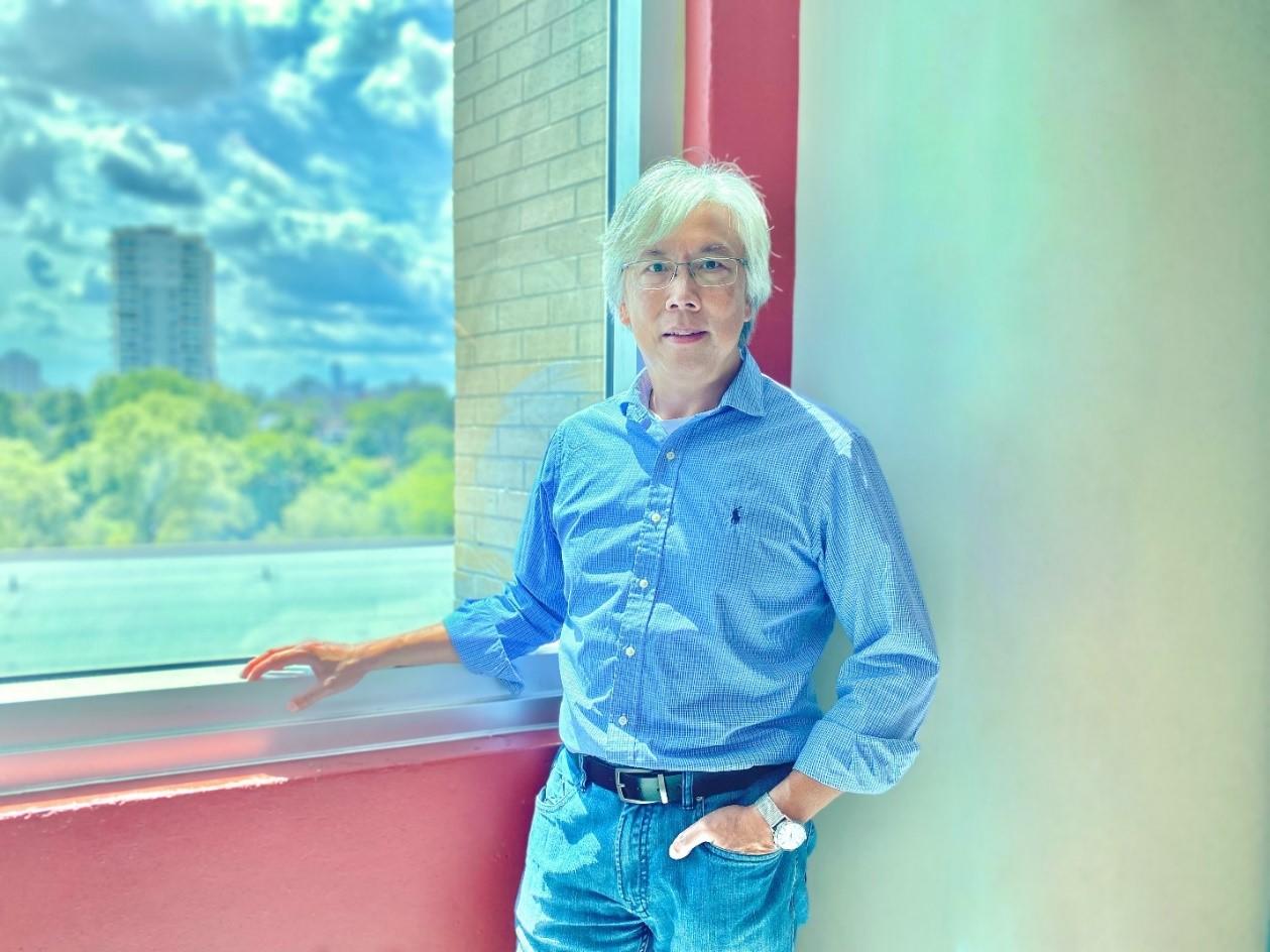 Prof. Laurie Chan posing in front of a window