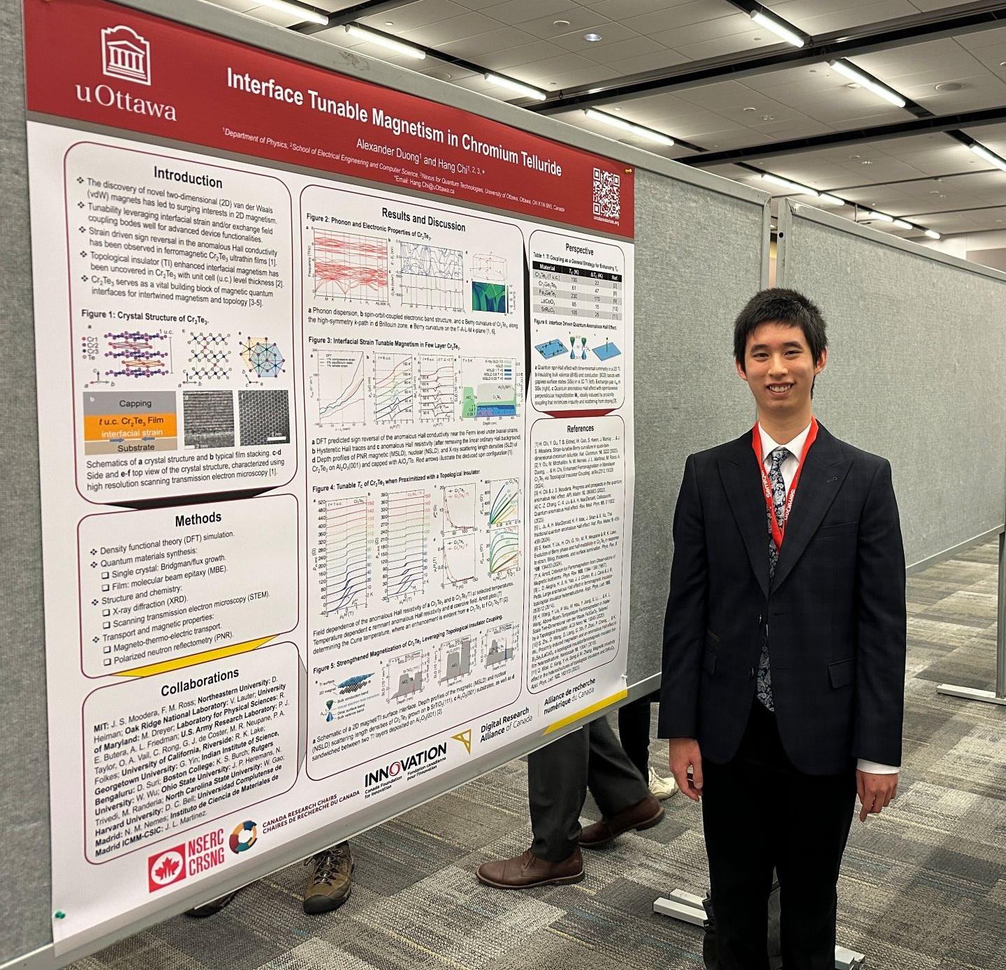 Alexander Duong stands beside his poster titled “Interface Tunable Magnetism in Chromium Telluride” at a scientific conference.