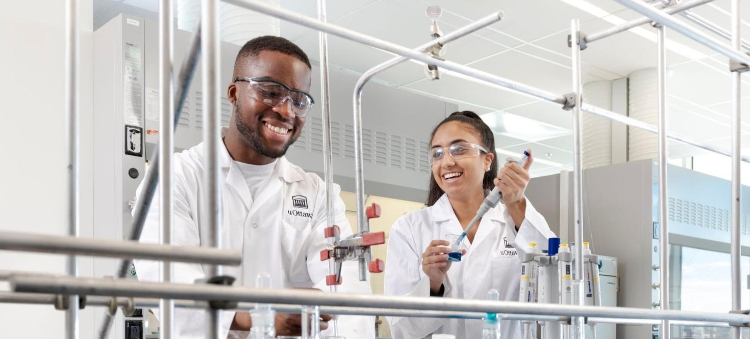 Two students working in a chemistry lab