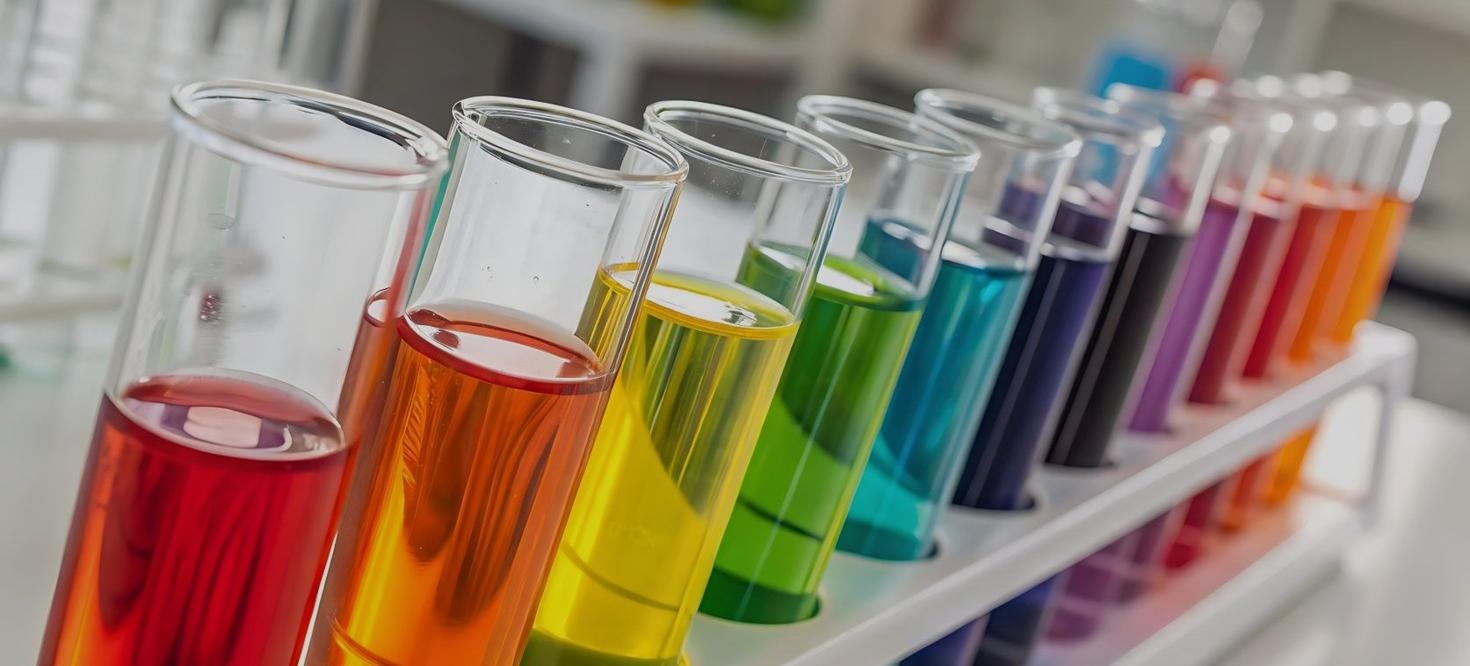 Colorful liquid samples in test tubes arranged in a laboratory rack 