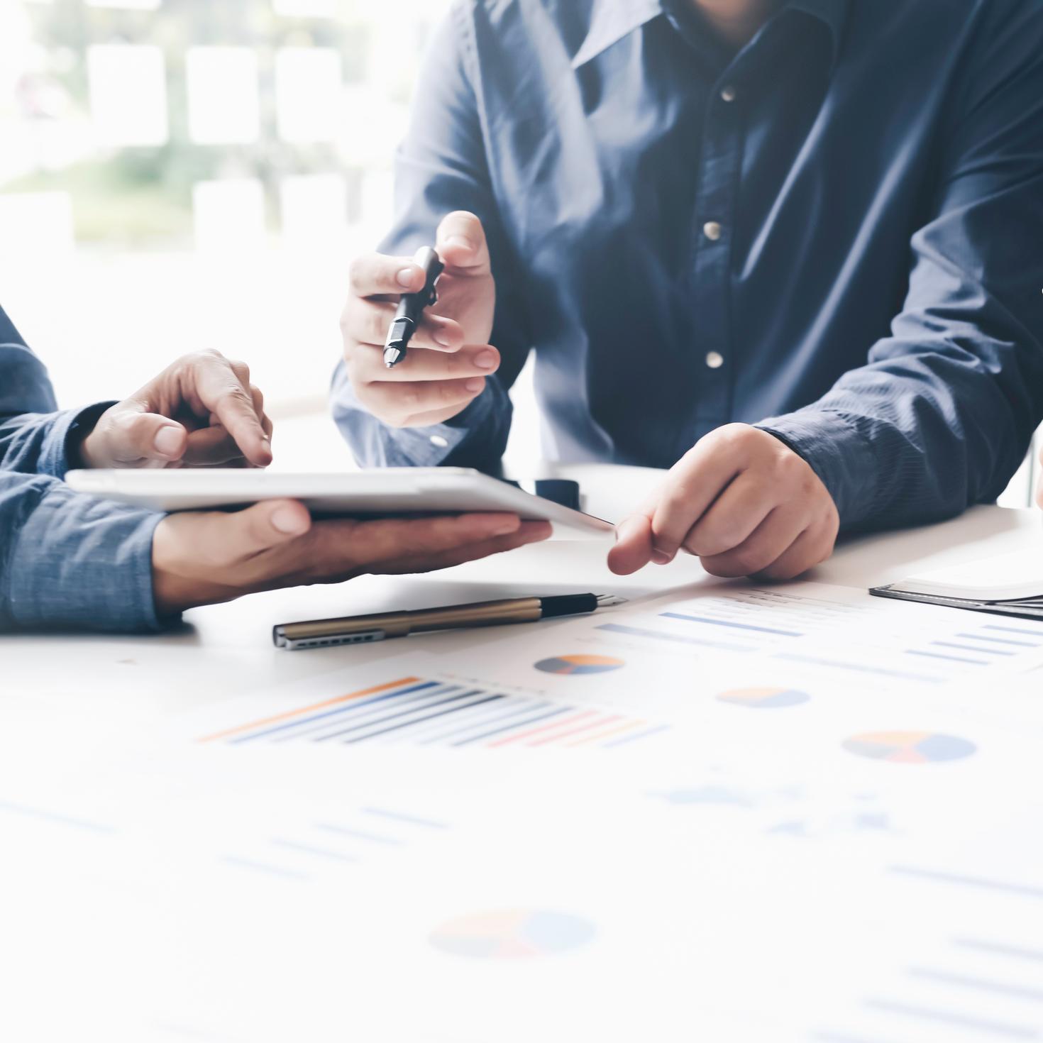 People interacting over financial documents