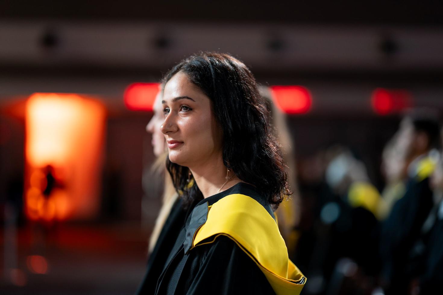 Female student wearing a graduation gown at the spring convocation