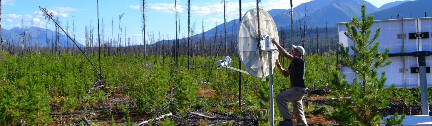 Professor Pascal Audet installing research equipment on a land.
