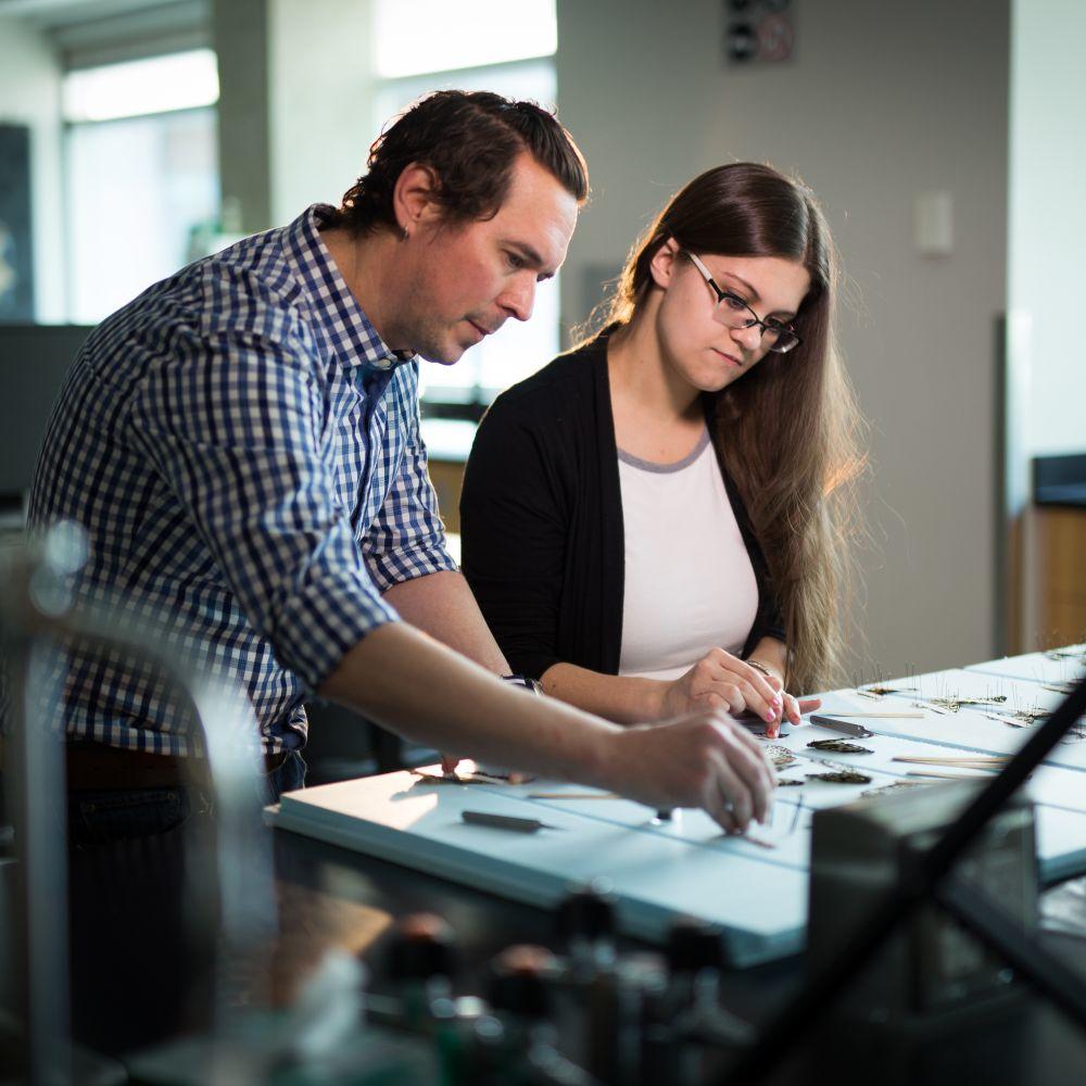 Professor Adam Brown with student.