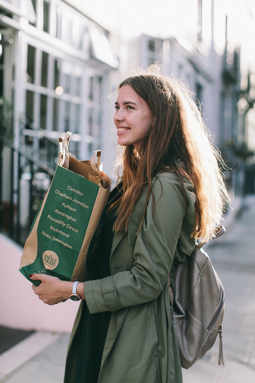 A person carrying their Whole Foods grocery bag