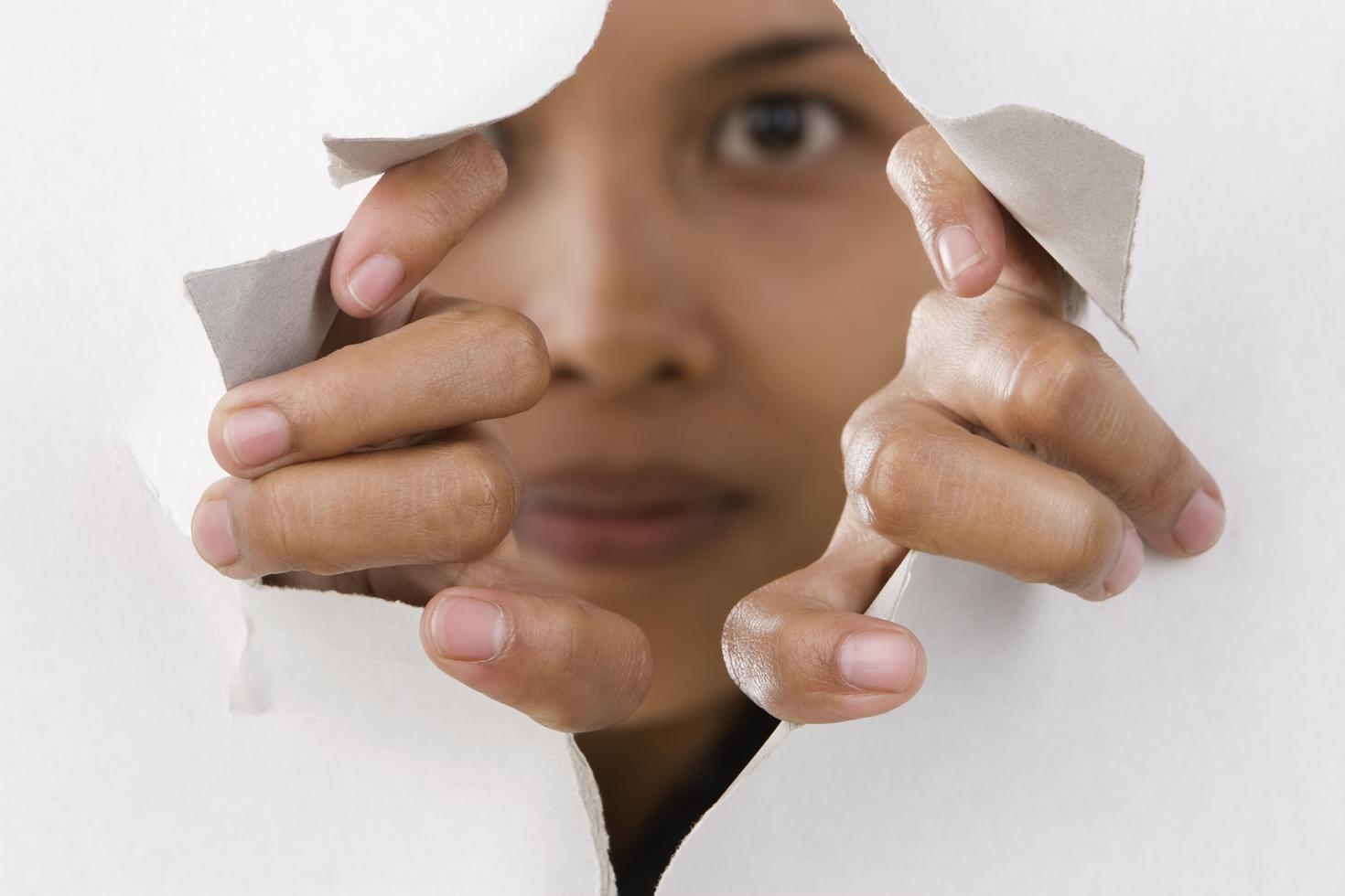 Person looking through a hole