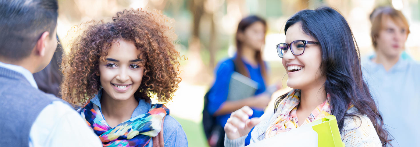 Students talking to teacher on campus