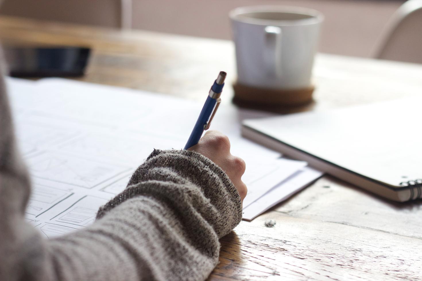 student writing on paper