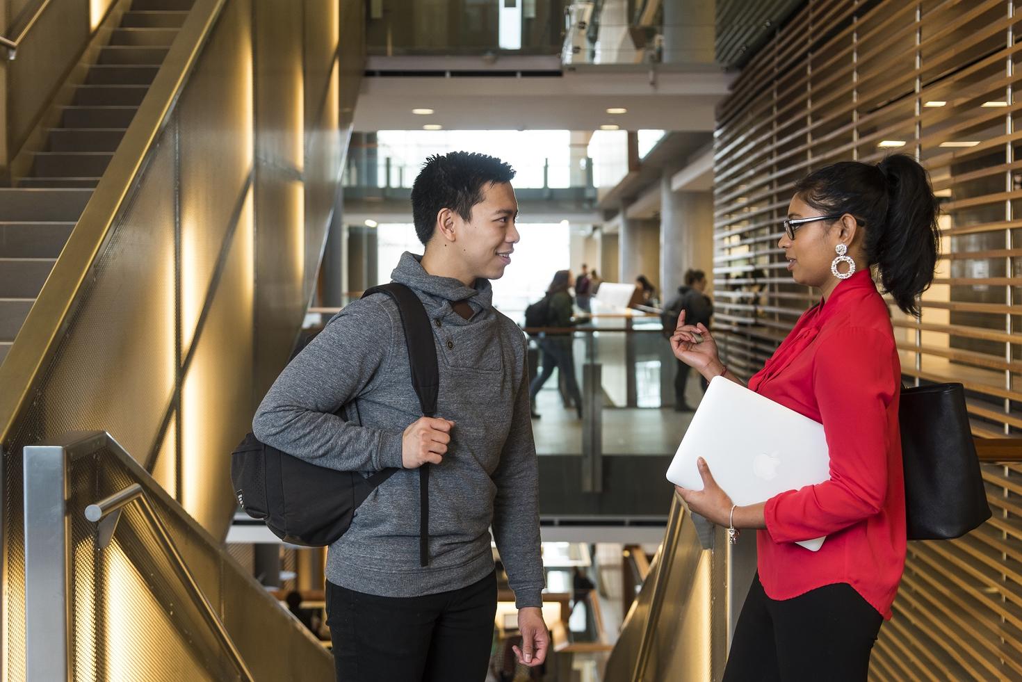 two students in conversation near Social Sciences' stairs