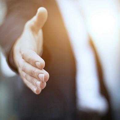 person reaching out in handshake