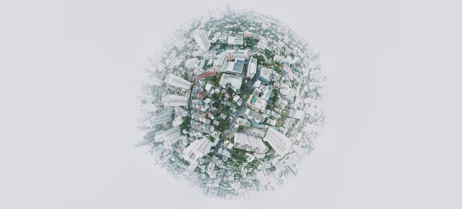 Circular fish eye view of city taken from above.