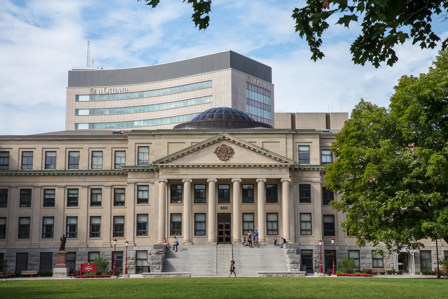 Exterior of Tabaret Hall, with students.