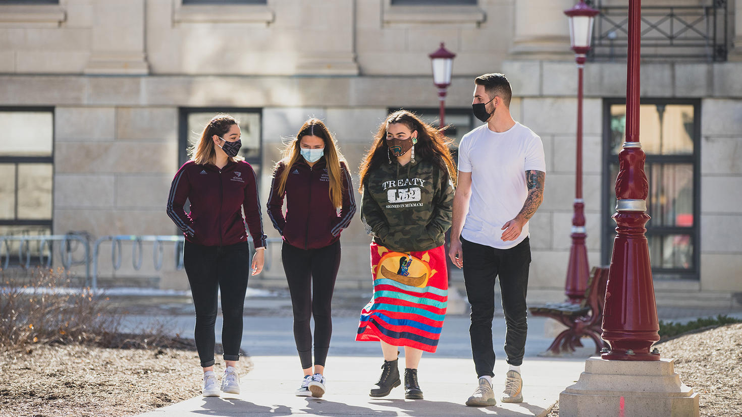 indigenous students walking through campus