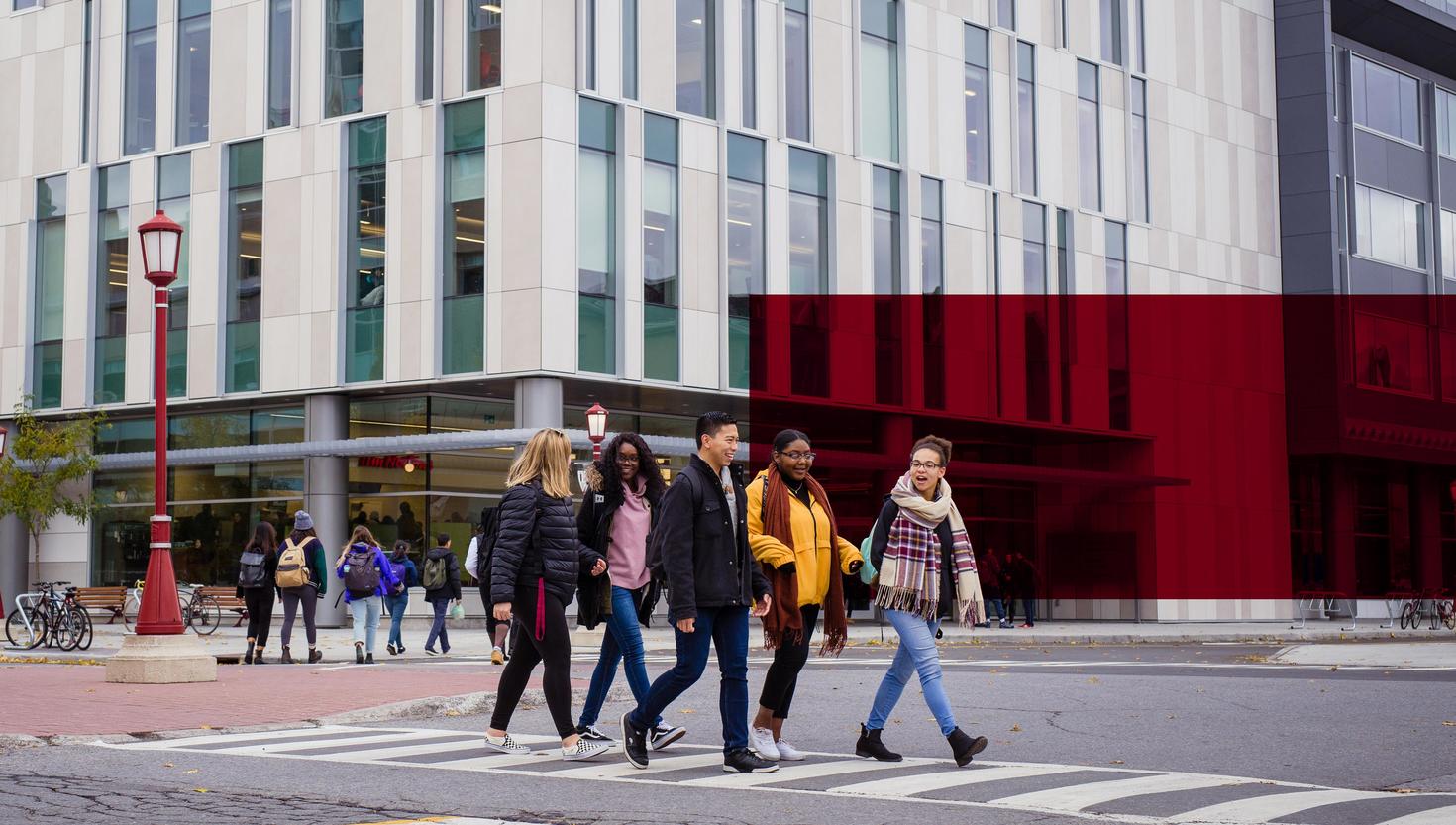 branded image of students walking outside university building