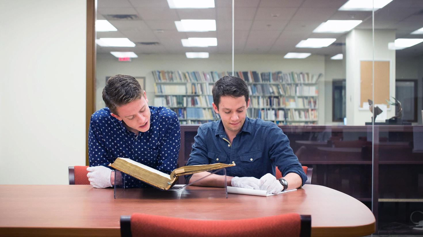 Students looking in a book