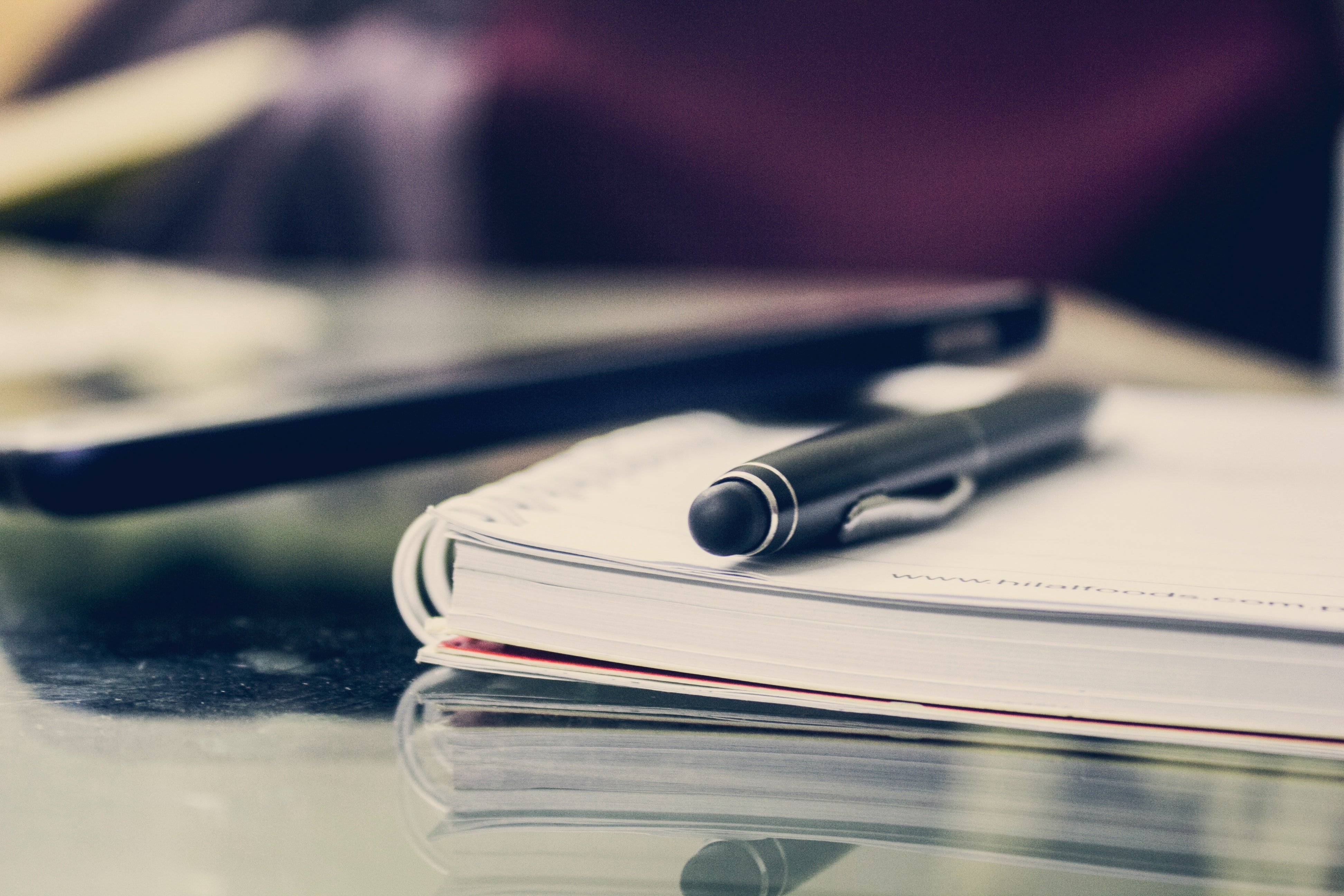 A book on a table with a pen