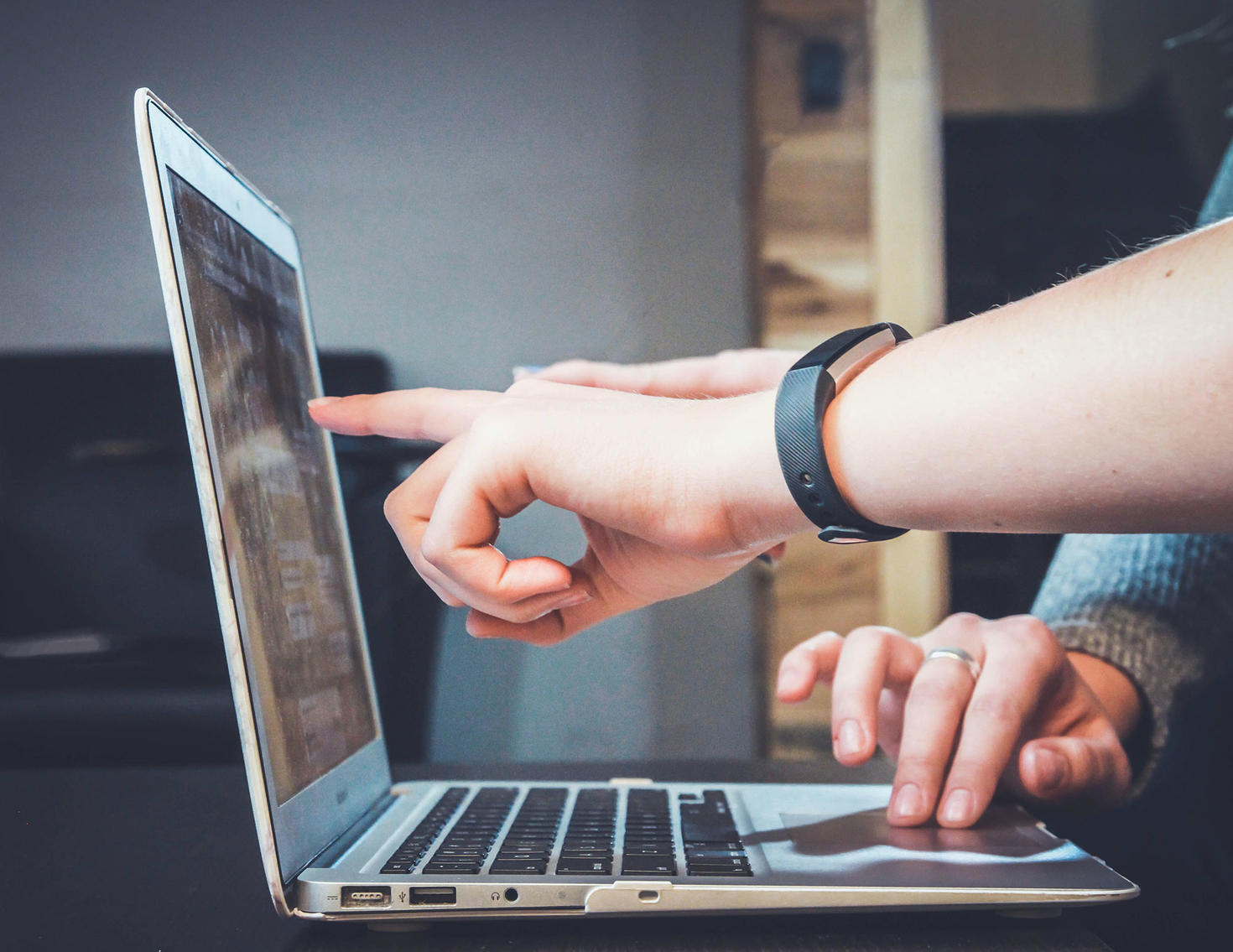 Hand in front of laptop