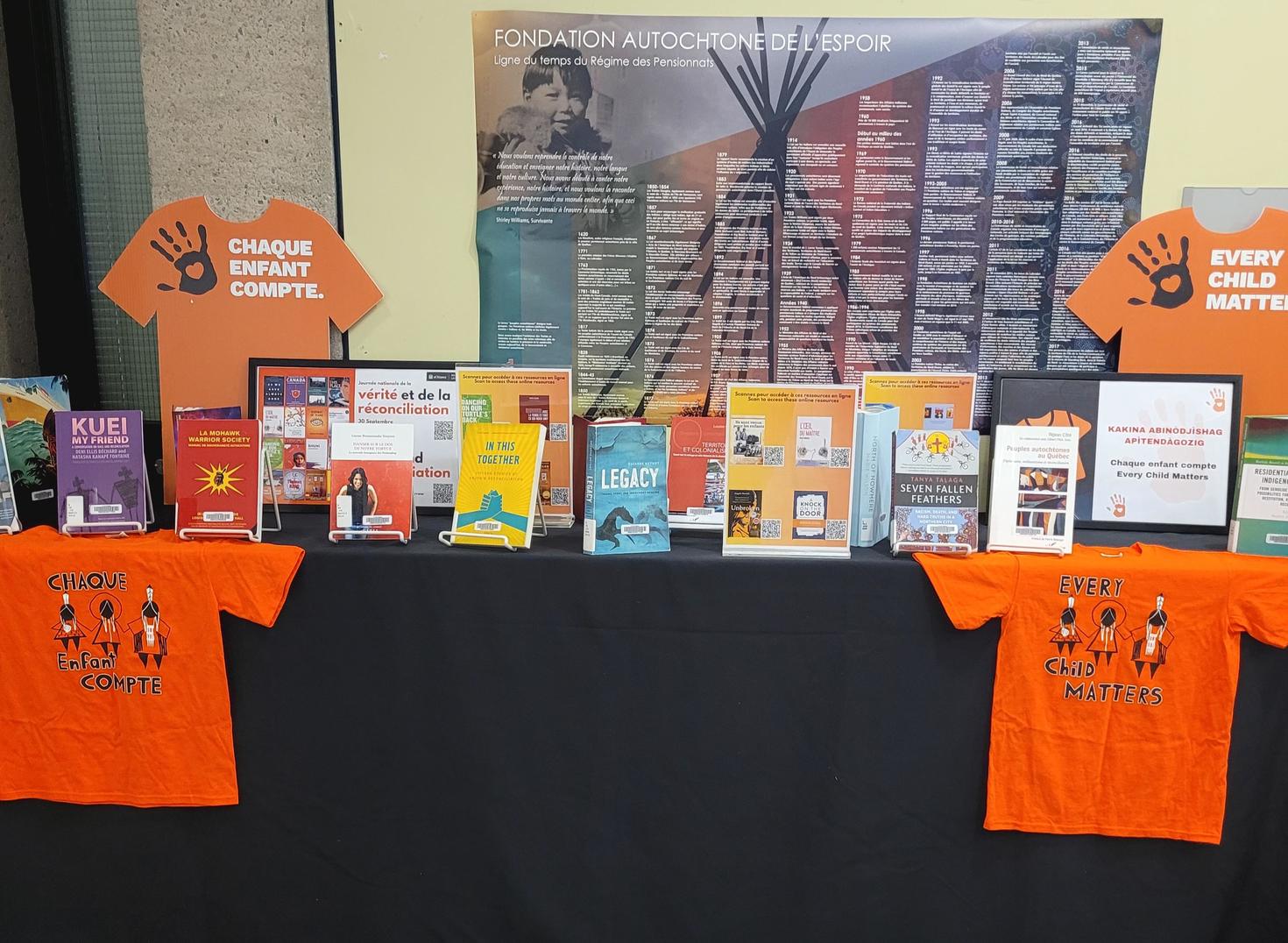 Display of books with a Orange T-shirts Every Child matters