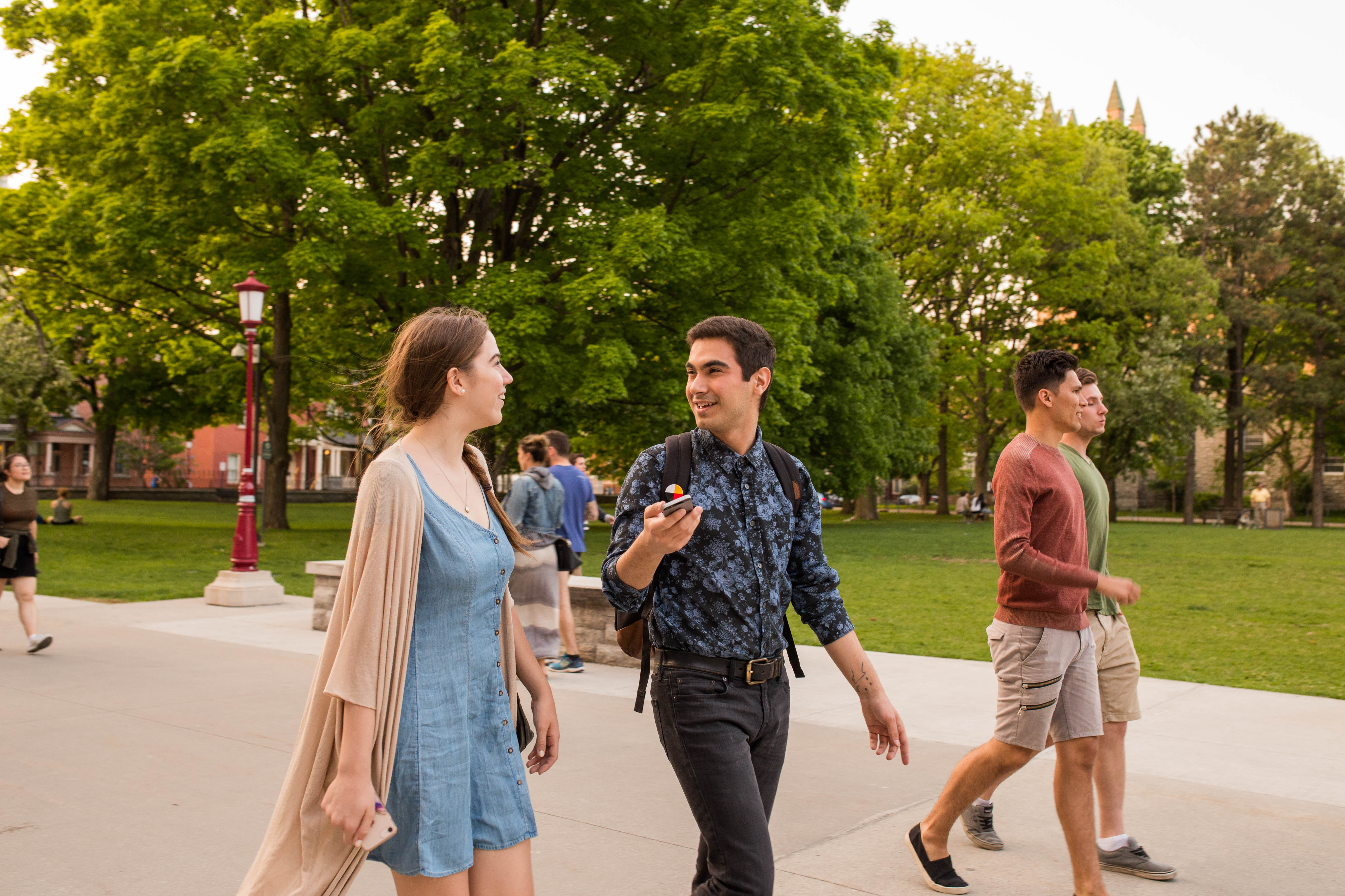 Two students talking to each other on campus.