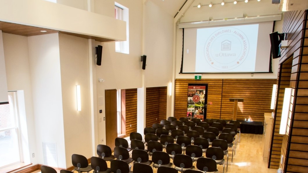 La salle avec des chaises et un écran pour projection.