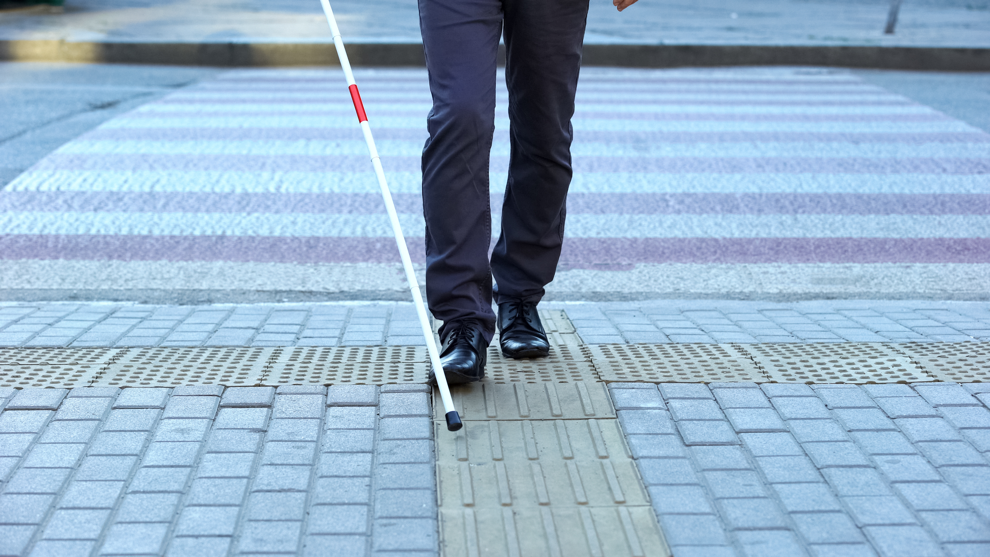 visually impaired person crossing the road.