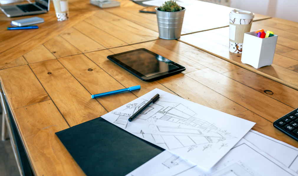 Architectural sketches on a wooden table 