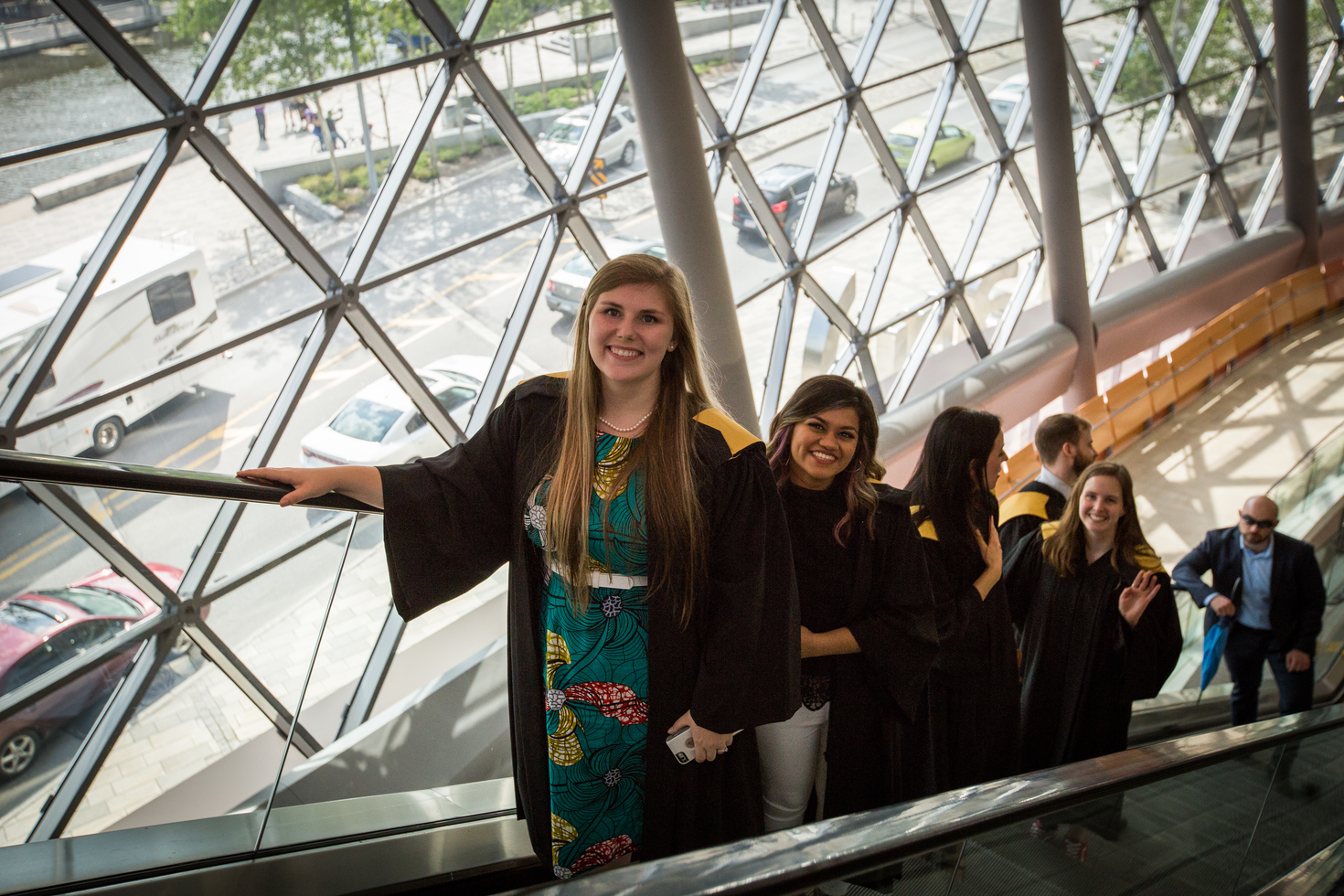 Étudiant diplômé sur l'escalator assistant aux collation des grades