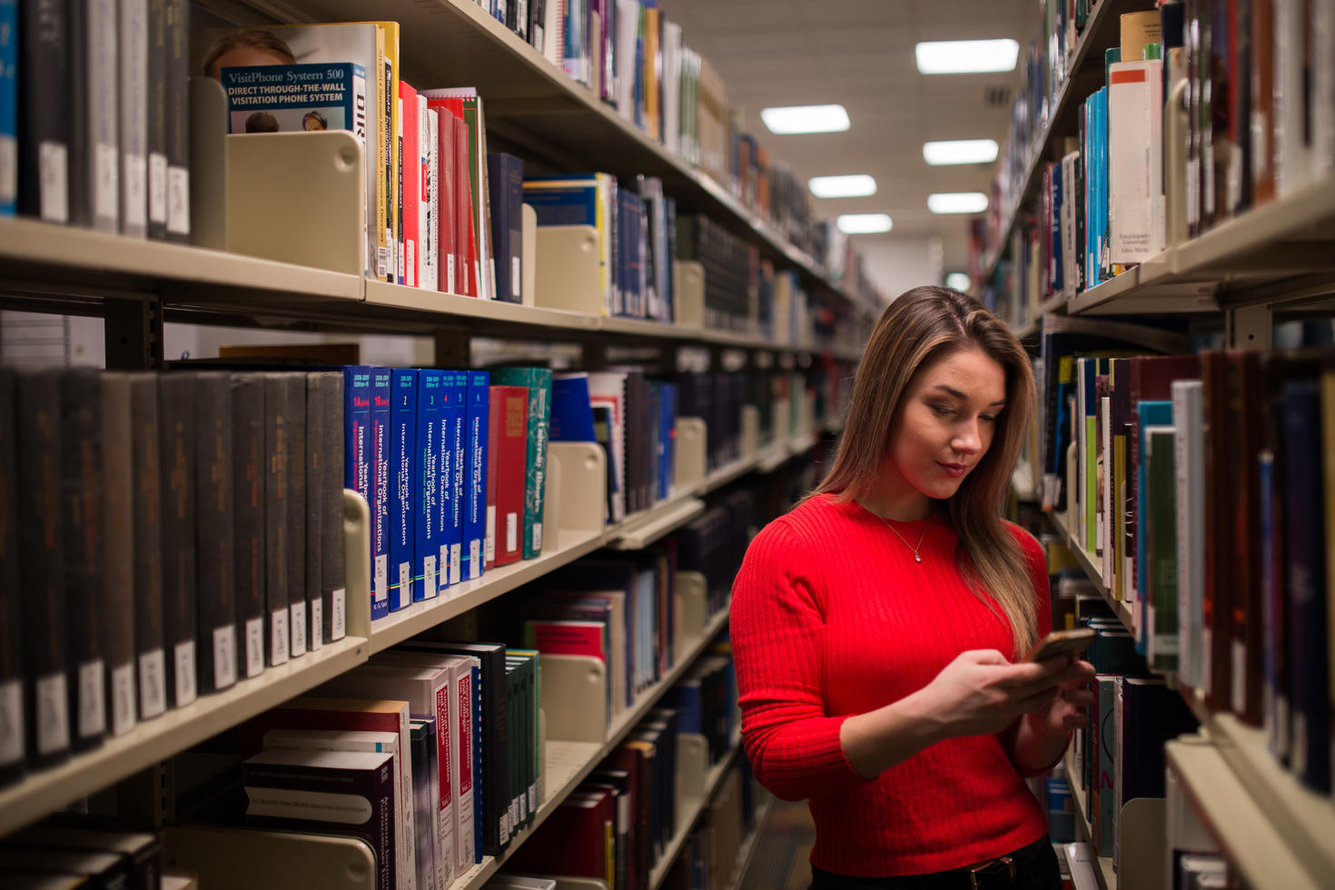 A woman stands in the library
