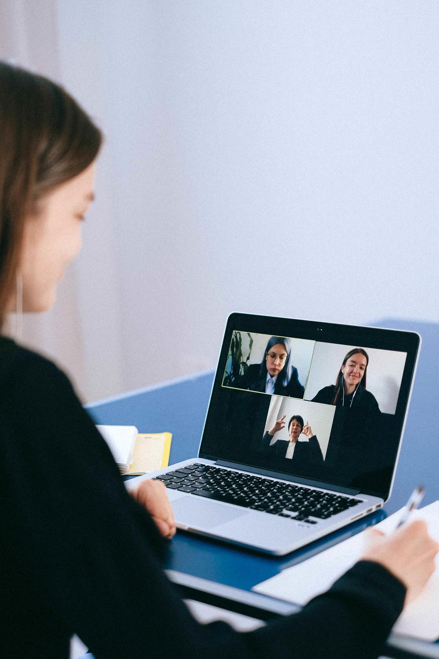 woman on a zoom call with 3 persons
