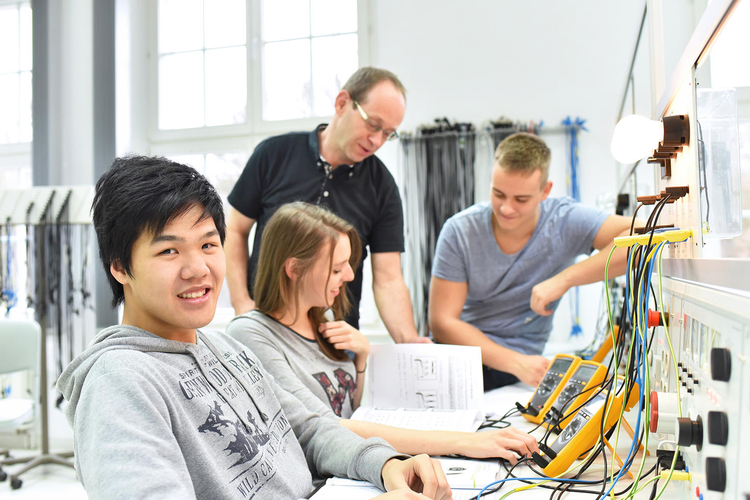 Group of young people in technical vocational training with mentor