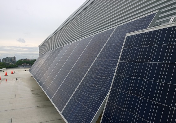 Deux grands panneaux photovoltaïques sur le toit d’un bâtiment.