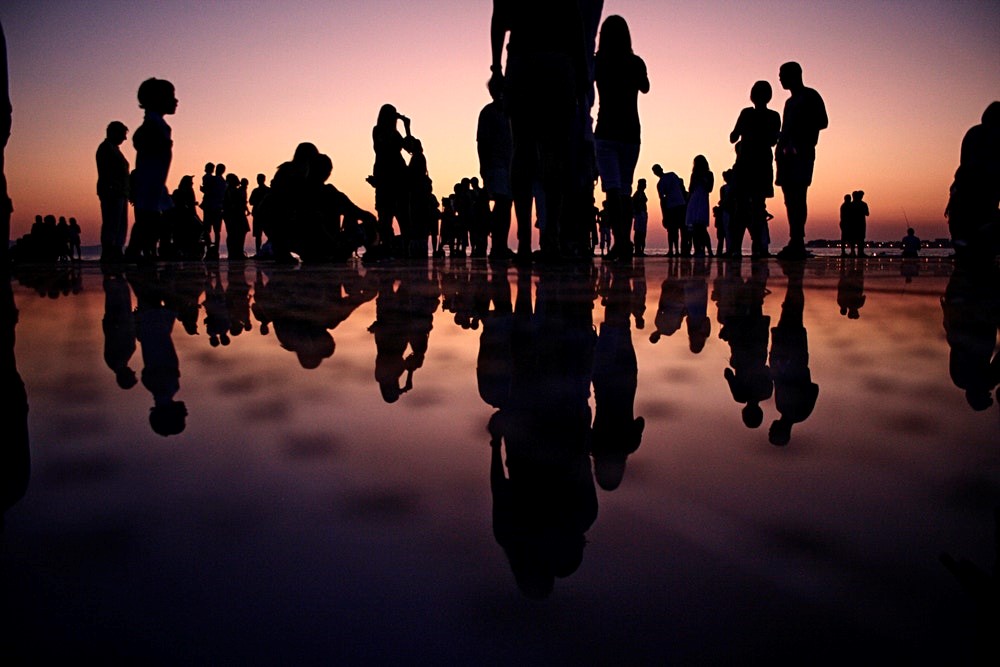 Silhouettes of people on a beach
