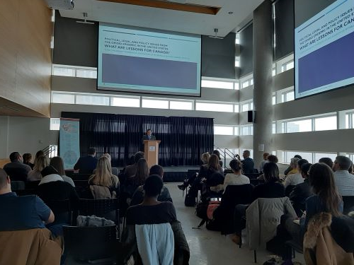 A presentation being given to a room full of people.