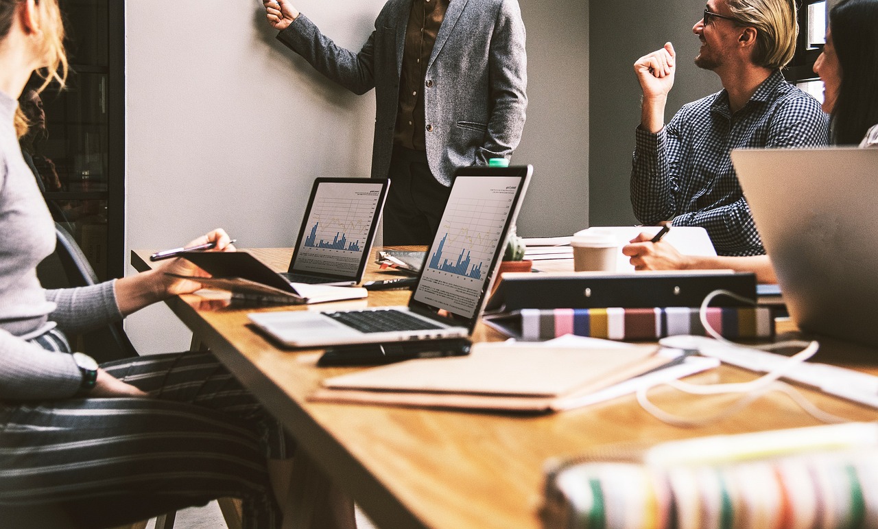 Une équipe travaillant à une table avec des ordinateurs portables et des documents