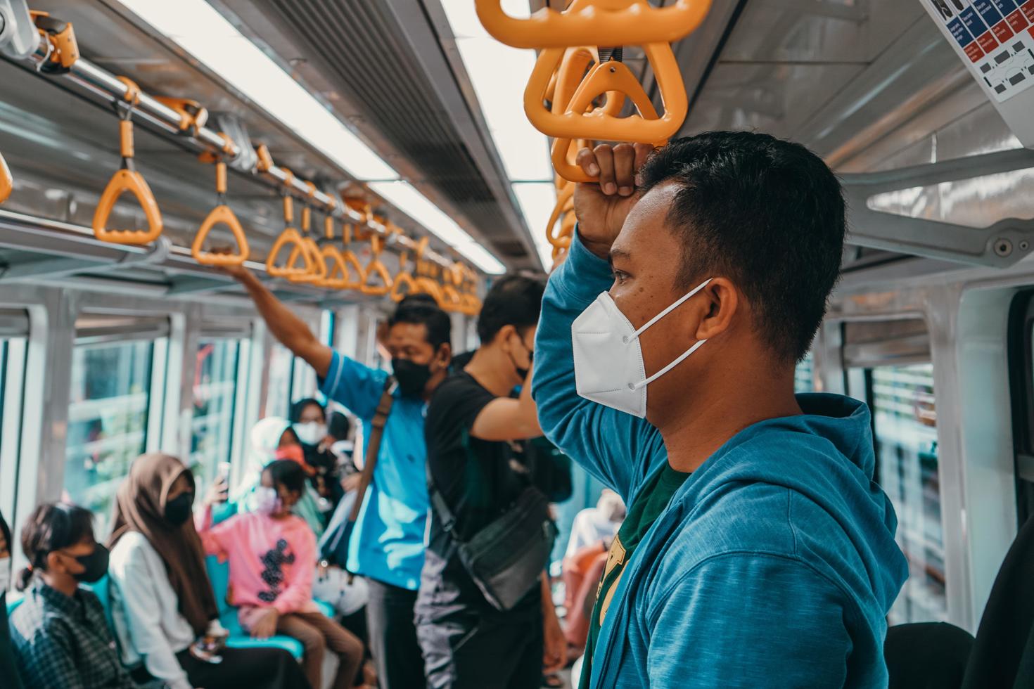 Masked public transit passengers.