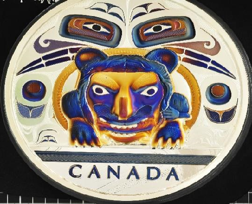 A circle with colourful eyes and a tiger with CANADA written underneath