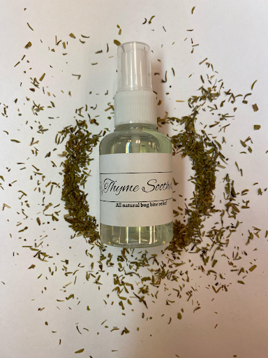 bottle of thyme spray surrounded by dried thyme