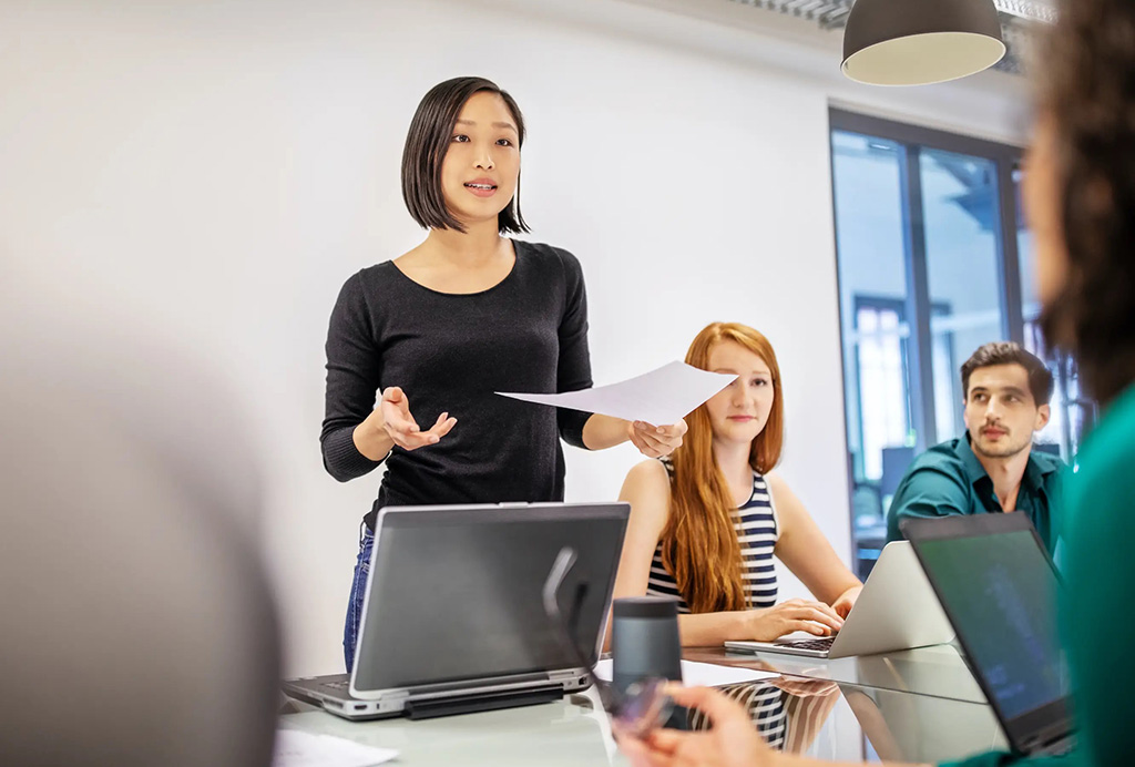 A woman presenting in a group meeting.