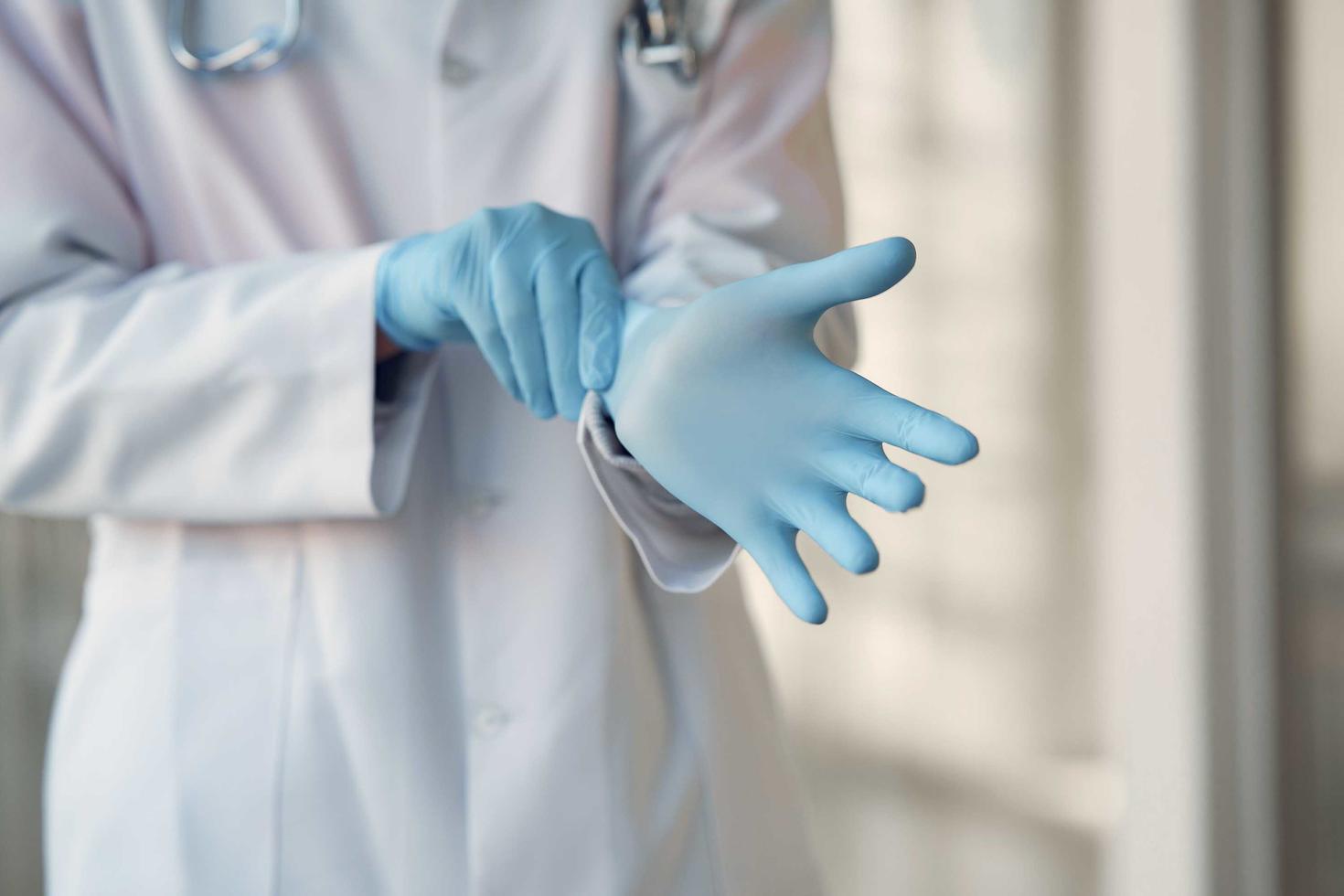 A doctor putting sanitary gloves