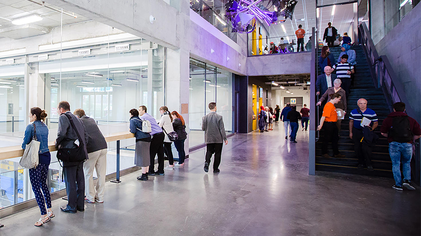 People exploring and taking pictures inside the STEM building
