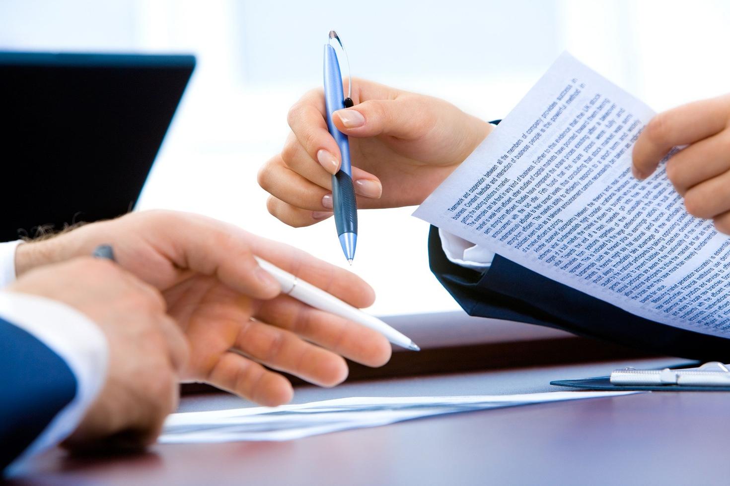 close-up on hands working on papers