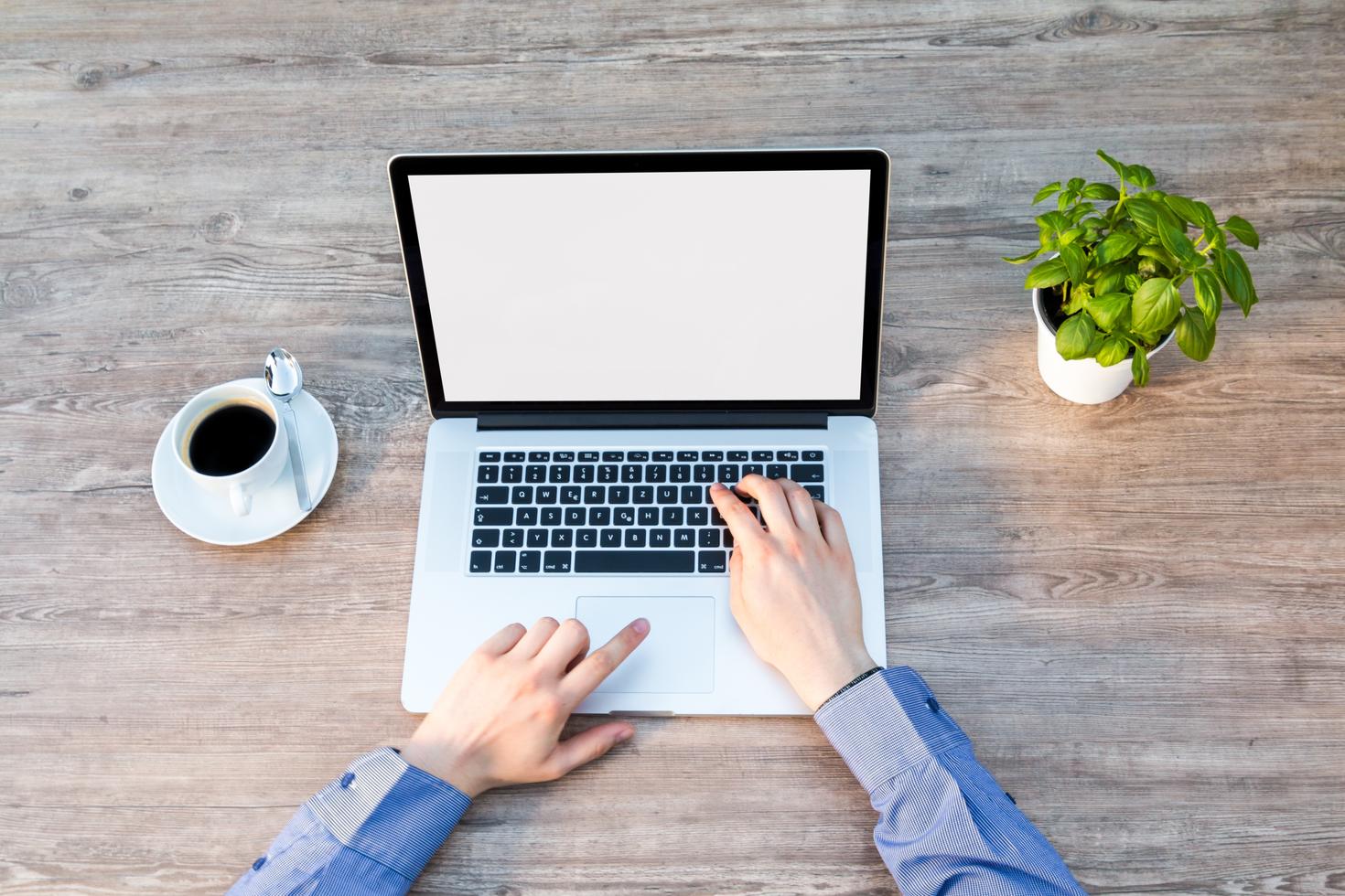 Hands on a laptop keyboard