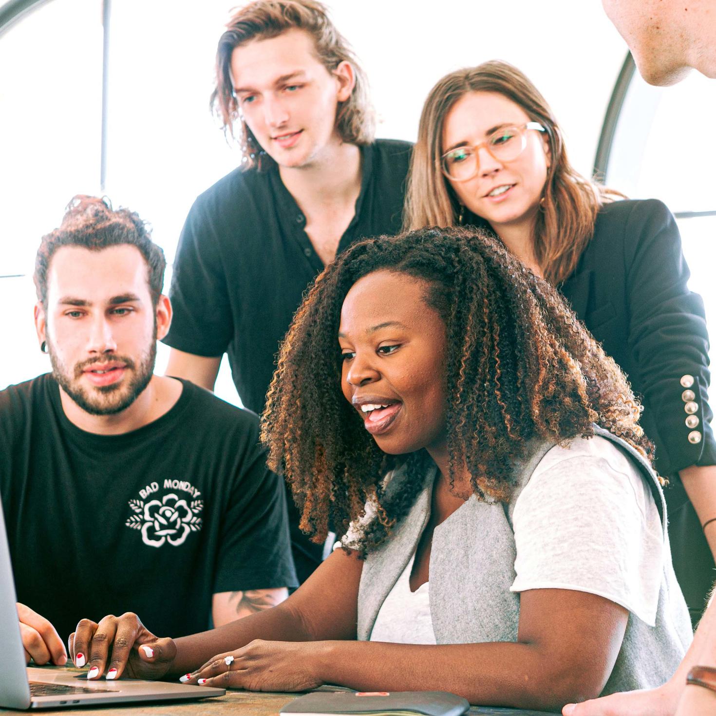 A group of people working together in front of a computer