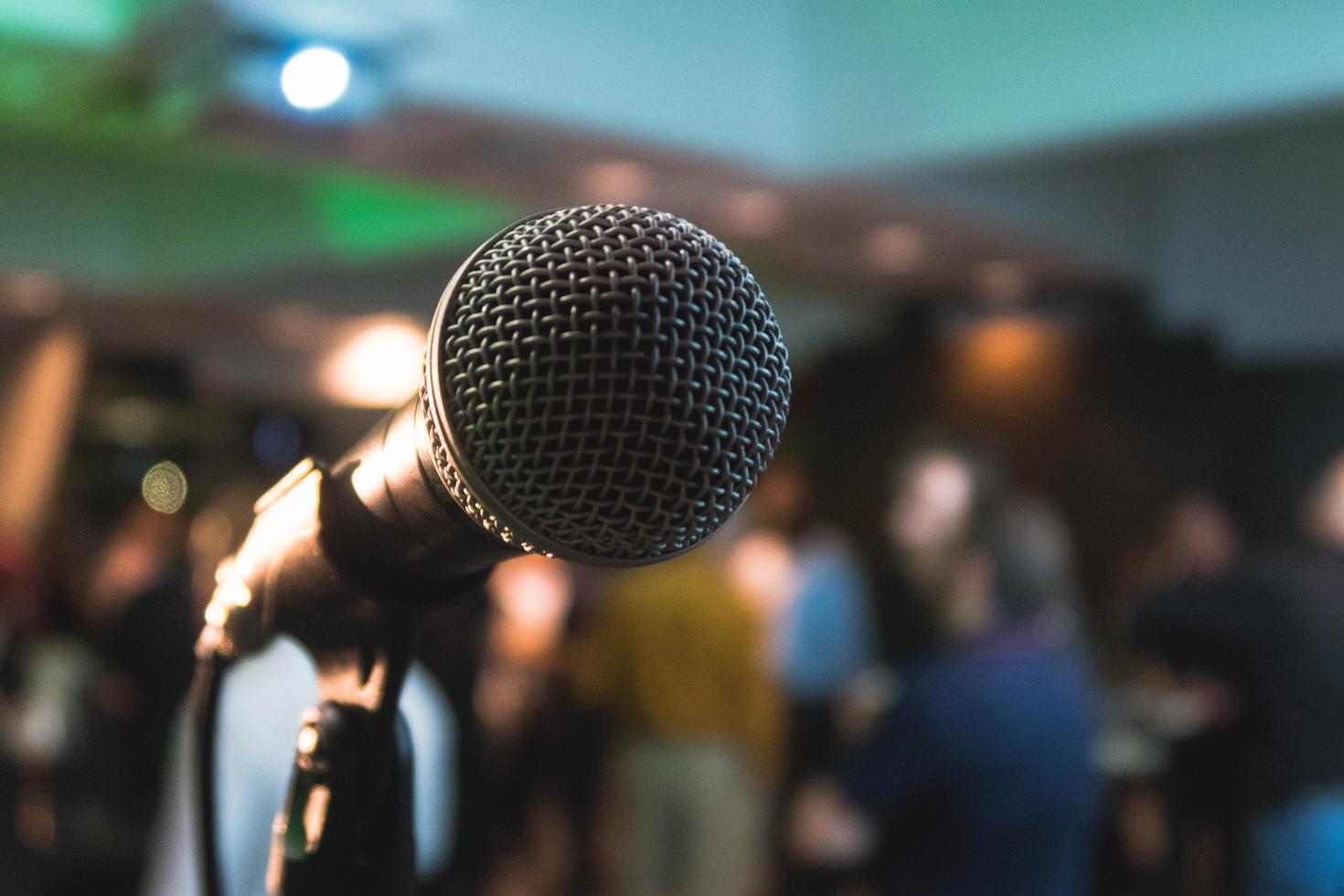 Microphone with audience in the background.
