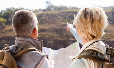 Two people pointing to something in the distance.