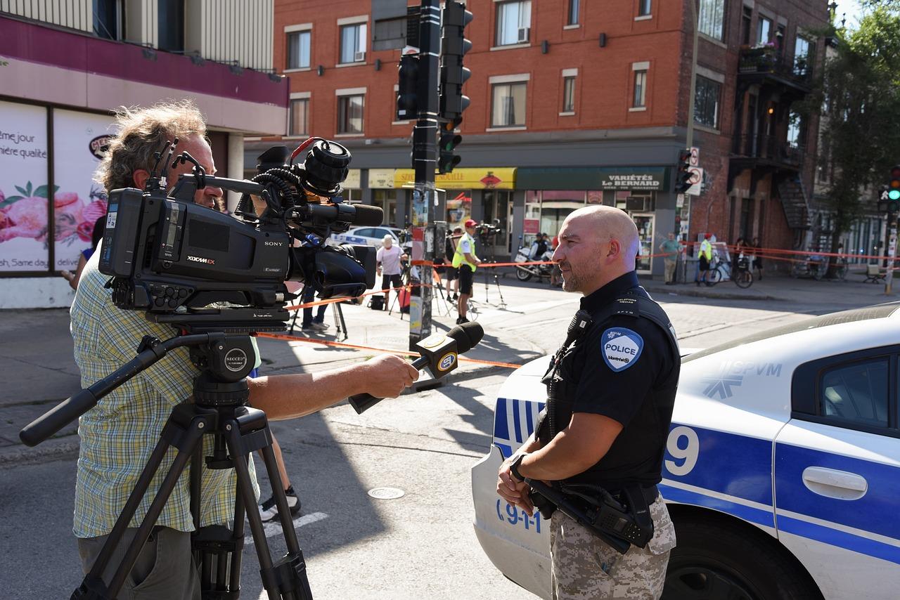TV journalist interviewing Montreal police officer