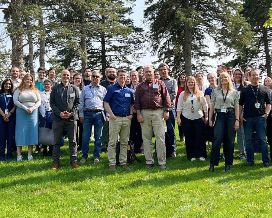 A group of uOBMRI members and trainees standing and smiling together outside.