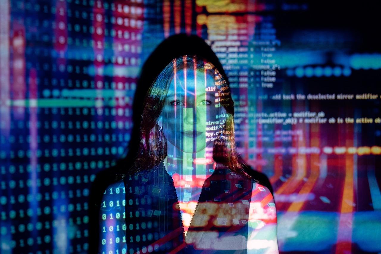 Silhouette of woman standing behind a colored data glass wall